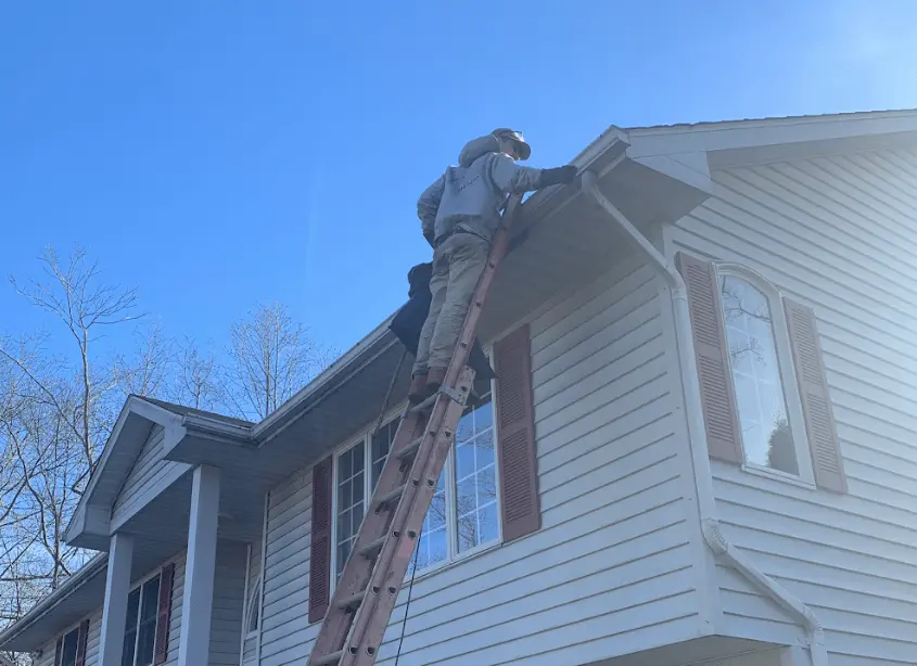 Gutter cleaning and maintenance being performed by Akron Power Washing in Akron